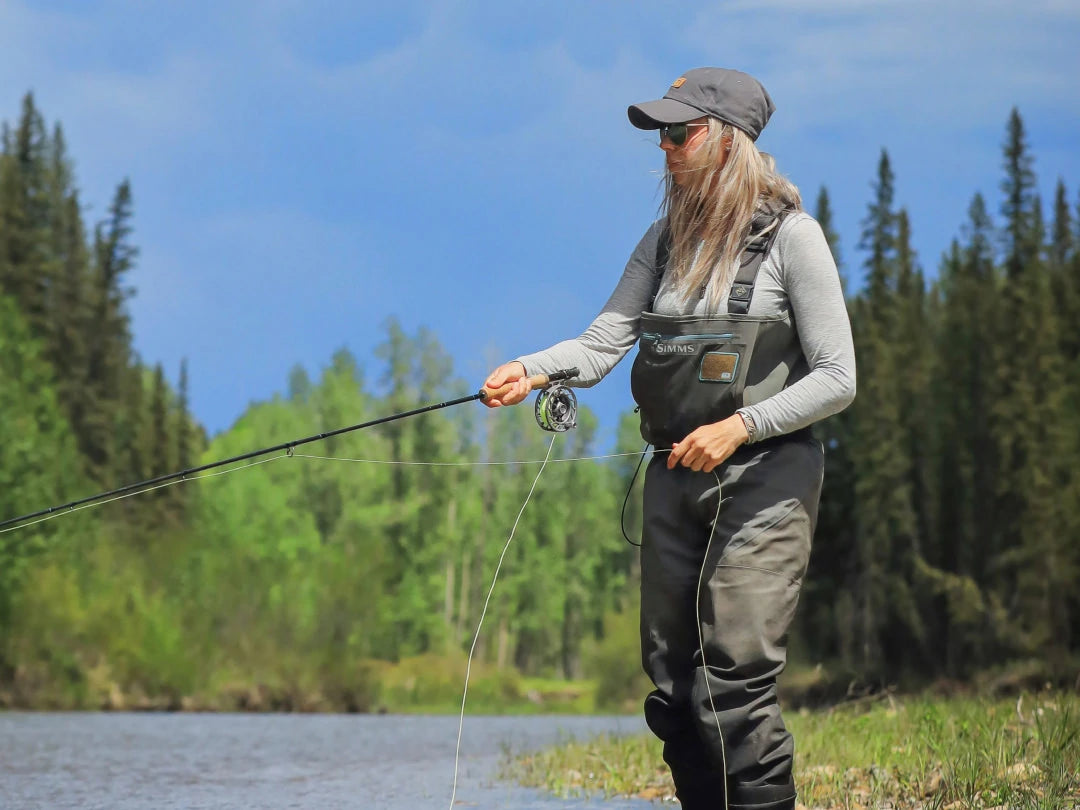 Woman fishing in her grey baselayer