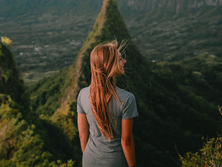 A girl in the nature wearing a blue alpaca tee 