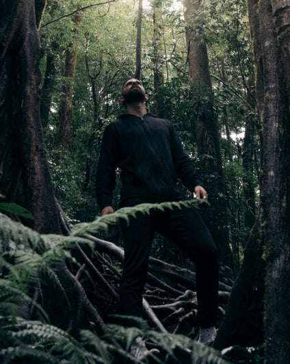 Man wearing our black Breathe Men's Full Zip and joggers in the forest