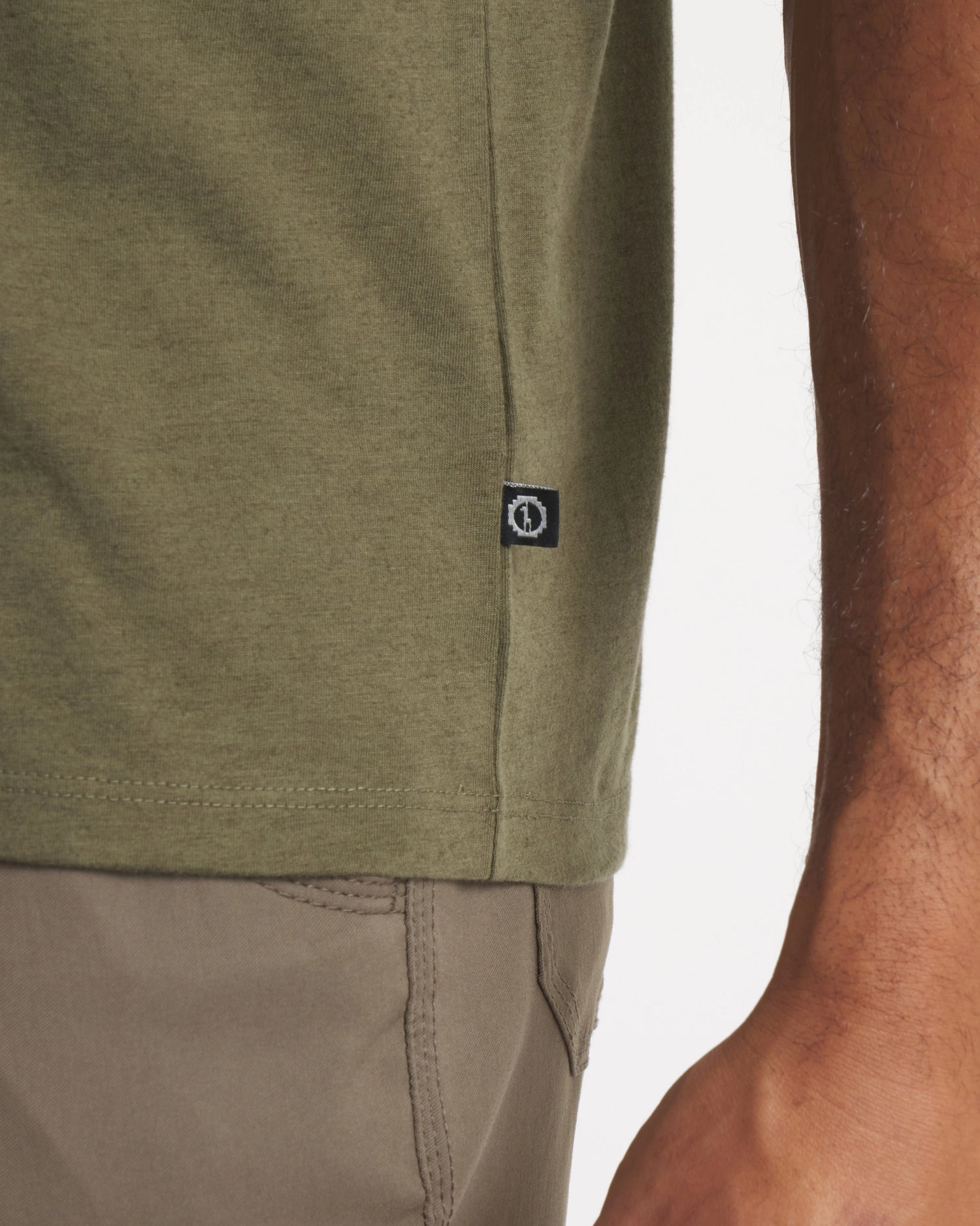 Side Waist View of PAKA Tag on Essential Tee Breathable Men's Alpaca T-Shirt in Andean Moss / Dark Green – PAKA Apparel