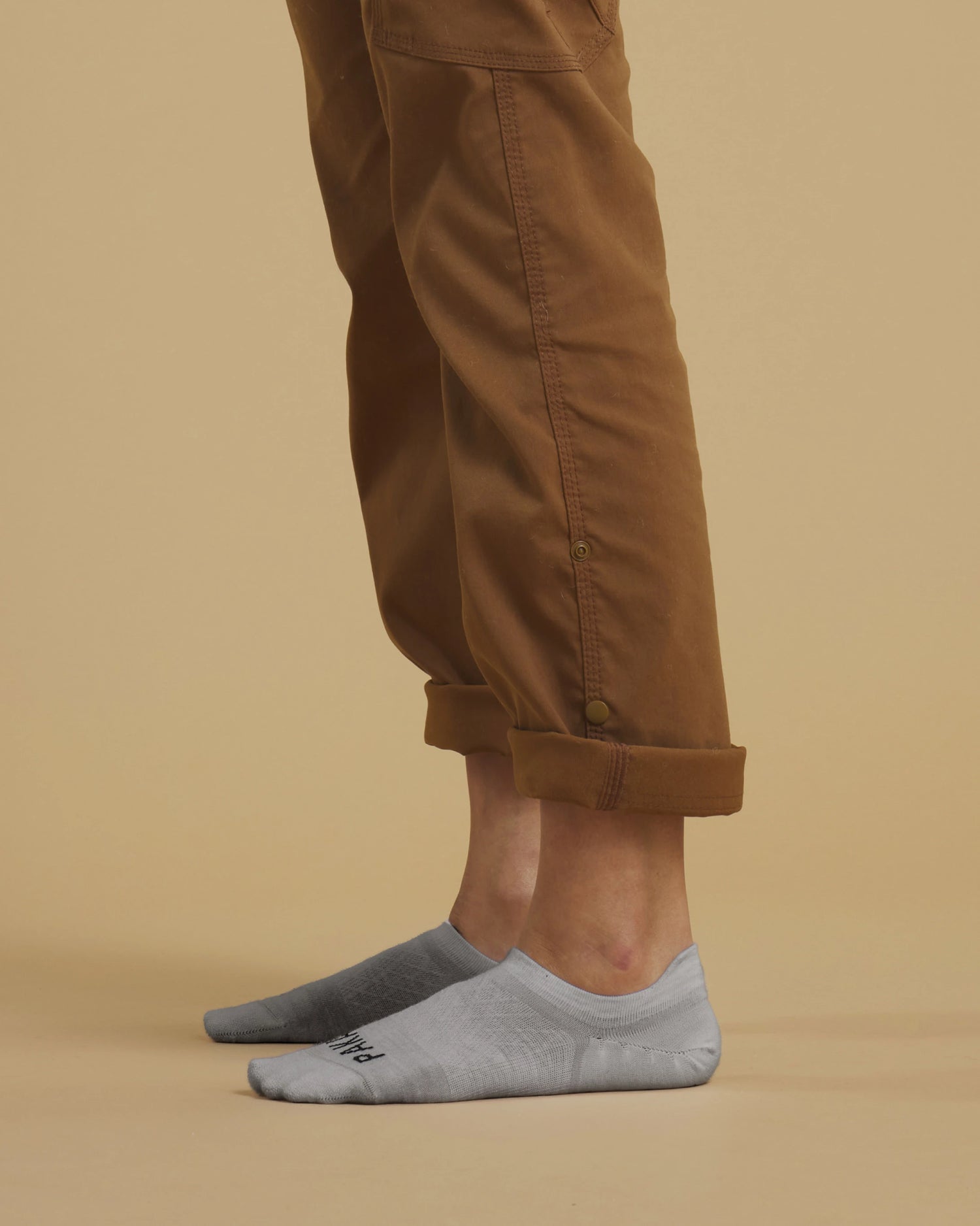 Light Grey Essential Alpaca No Show Socks on Feet of Man with Cuffed Pants Standing Sideways – PAKA Apparel