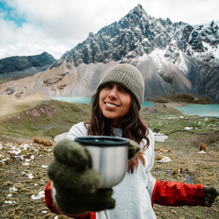A lady showing a cup at Ausangate in Peru