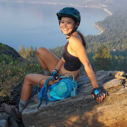 Smiling woman climbing rocks wearing her cozy alpaca socks