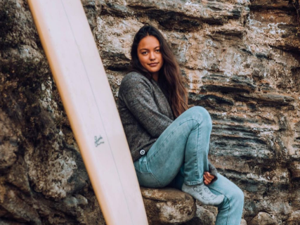 A girl with a surfboard wearing the Sebastian Socks