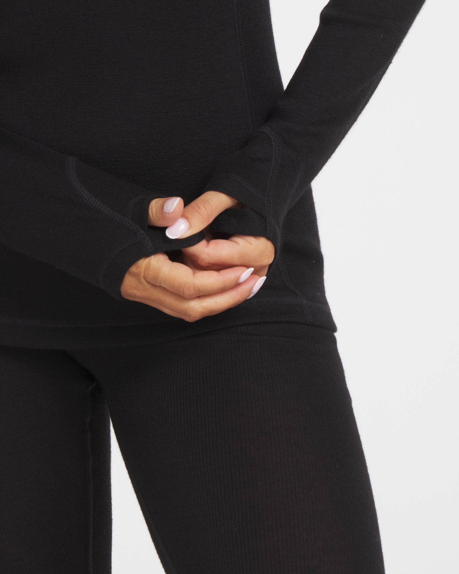Model’s Hands Through Thumbholes of Women's Black Thermal Hoodie Baselayer – PAKA Apparel