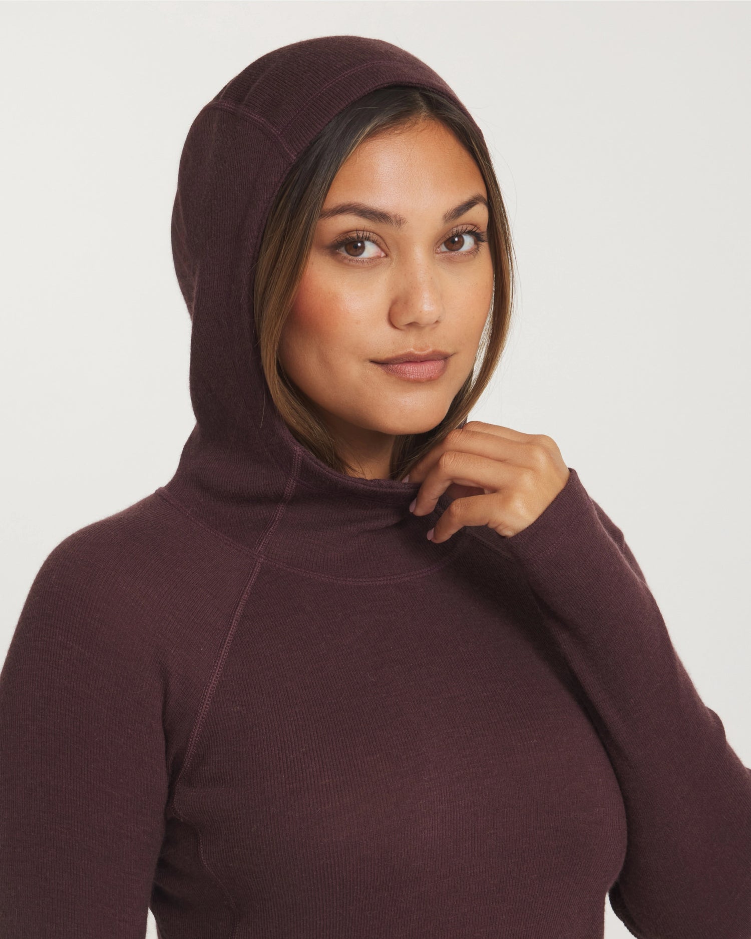 Close-Up of Model with Hood Up and Hand on Neckline of Women's Thermal Hoodie in Uva / Dark Purple – PAKA Apparel
