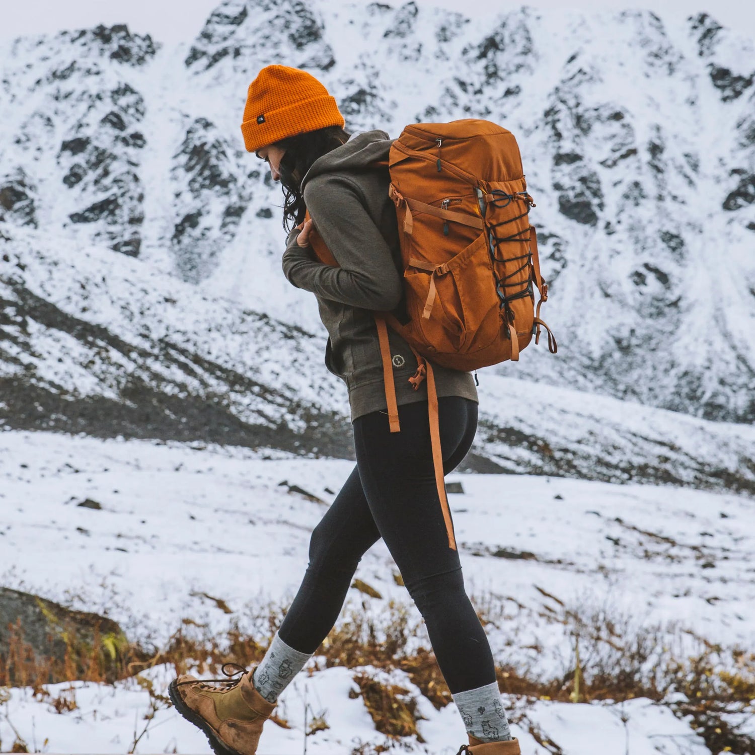 Woman in andean moss green breathe zip hoodie hiking in snow