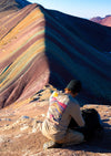 A man wearing our Explore Peru Long Sleeve in front of the Rainbow Mountain