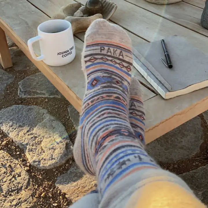 Taking a cup of coffee in their awesome Inca socks