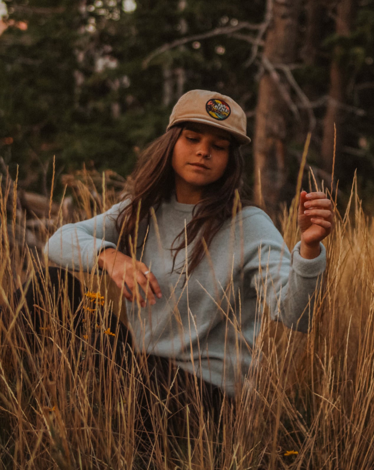 A girl wearing our Sky Blue Crewneck in the nature