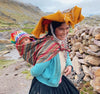 Quechua villager with her baby on her back on the treck to Ausangate