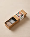 Box of socks with a colorful label on a beige background
