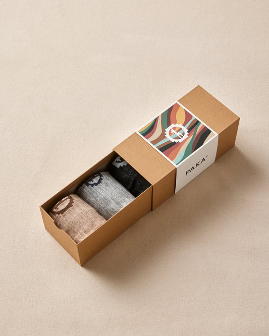 Box of socks with a colorful label on a beige background