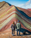 A couple standing a the lookout for Rainbow Mountain.