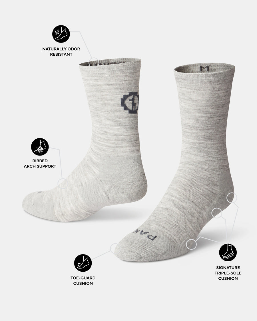 Light Gray socks with brand logo on a white background, featuring text about sock features.