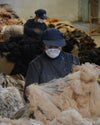 Two women working with alpaca fiber
