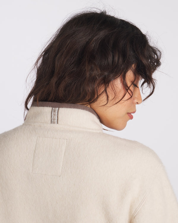 Woman wearing fleece in Oat