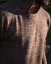 Close-Up of Man's Torso in Sun Wearing The Hoodie Peruvian Alpaca Sweater Hoodie in Flint / Light Brown – PAKA Apparel