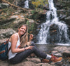 Alpaca Socks - Woman Wearing a cozy pair of socks with Boots on a natural adventure in front of a waterfall