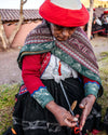 Quechua women weaving an alpaca bracelet