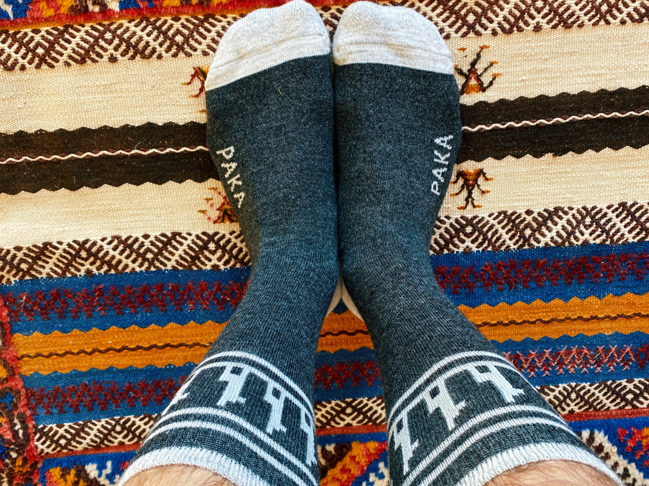 Our Charcoal Costa socks over a on a blanket with funny designs and patterns