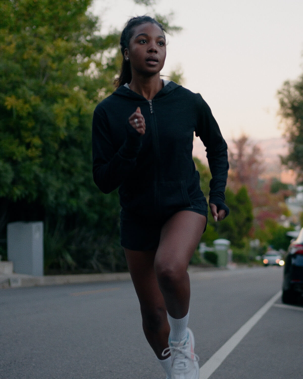 A woman wearing a black Breathe Women's Full zip running
