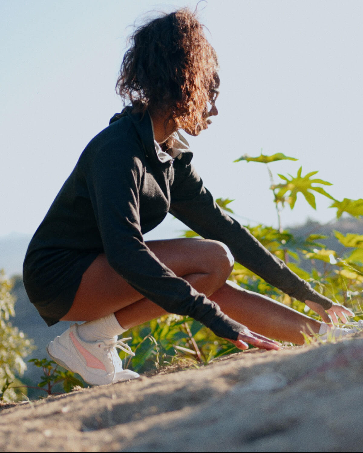 A woman wearing a black Breathe Women's Full zip excercising outdoors