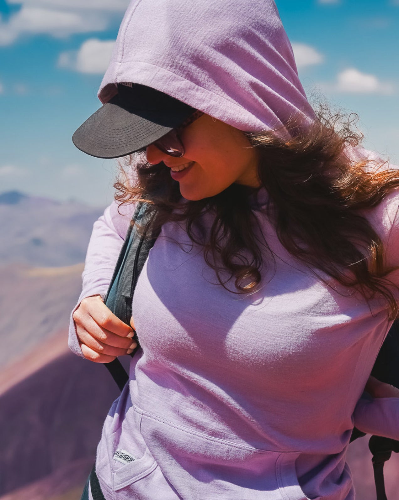 A woman wearing our lavender Breathe Women's Hoodie outdoors