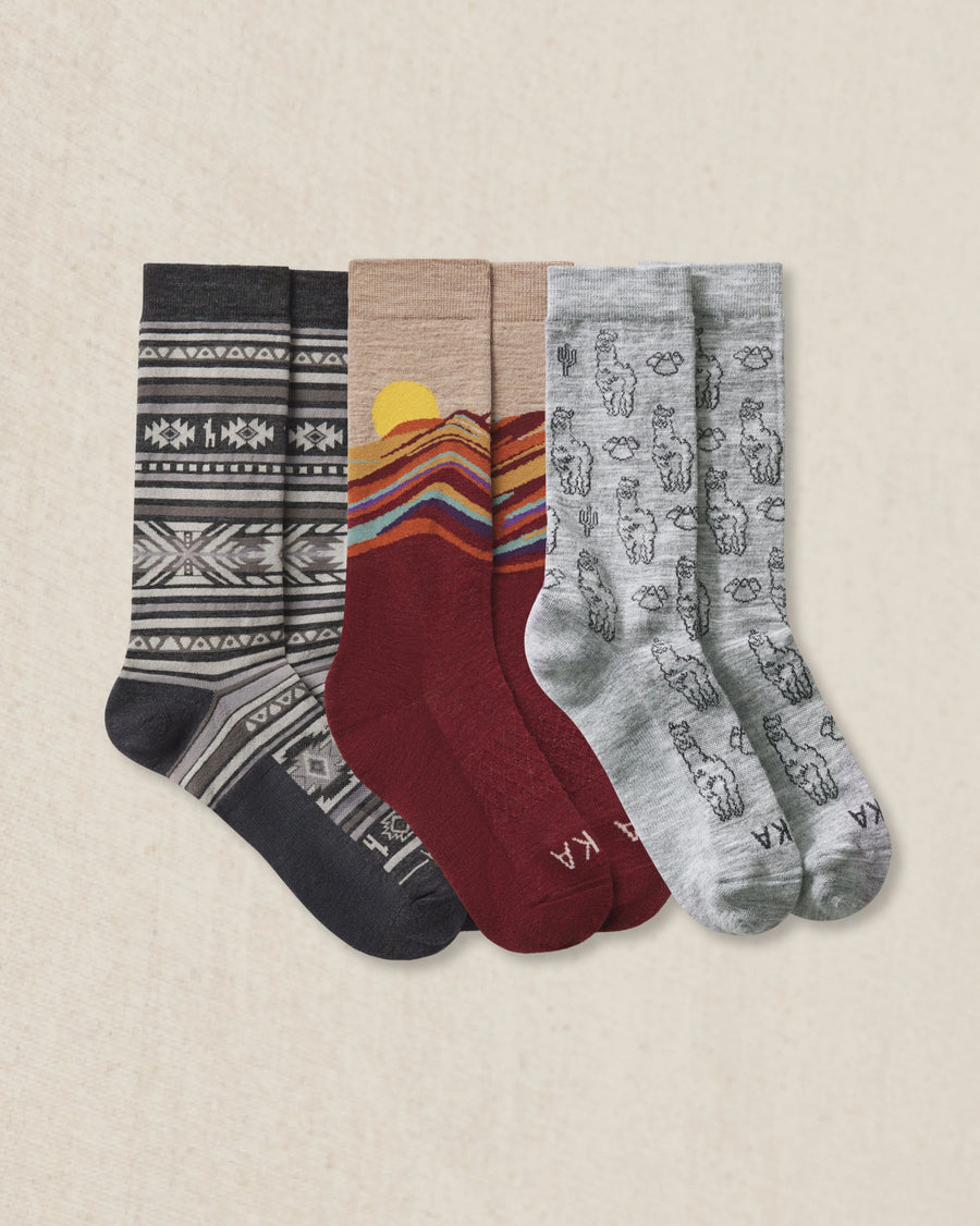 3 pairs of socks with different patterns on a beige background