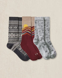 3 pairs of socks with different patterns on a beige background