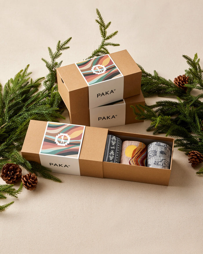Paka sock set in a box with Christmas decorations on a beige background