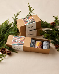 Paka sock set in a box with Christmas decorations on a beige background