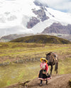 Woman walking a horse in front of Ausangate