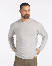 Three-quarter view of Lightweight Crew sweater in light grey, showing crew neck, ribbed cuffs and hem, relaxed fit on white
