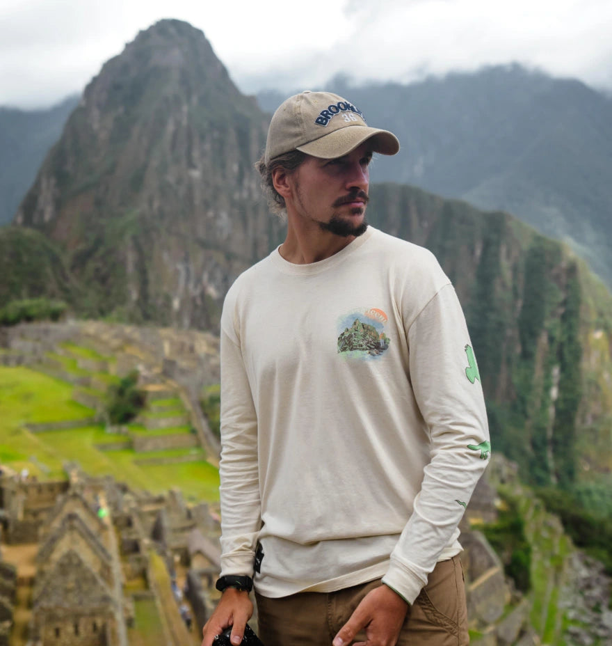 A man wearing a timber alpaca Long Sleeve next to Machu Picchu