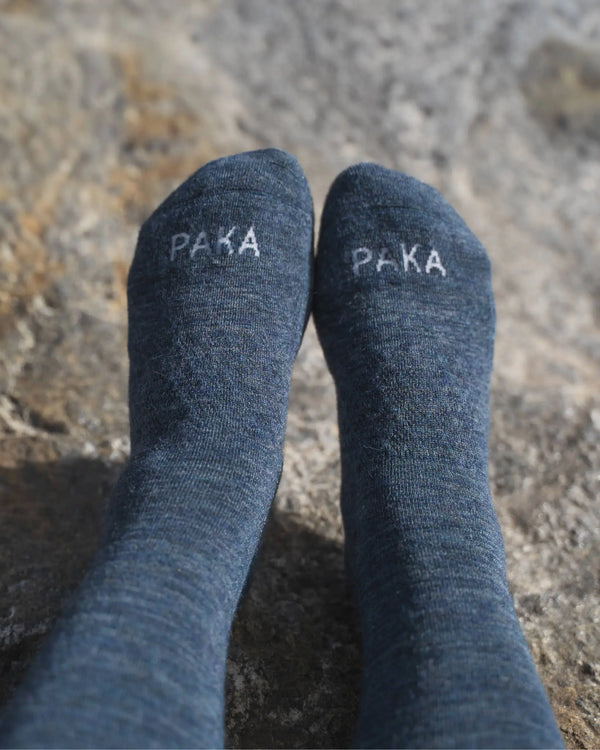 Close-Up of Navy Essential Melange Alpaca Crew Socks on Feet on a Rock – PAKA Apparel