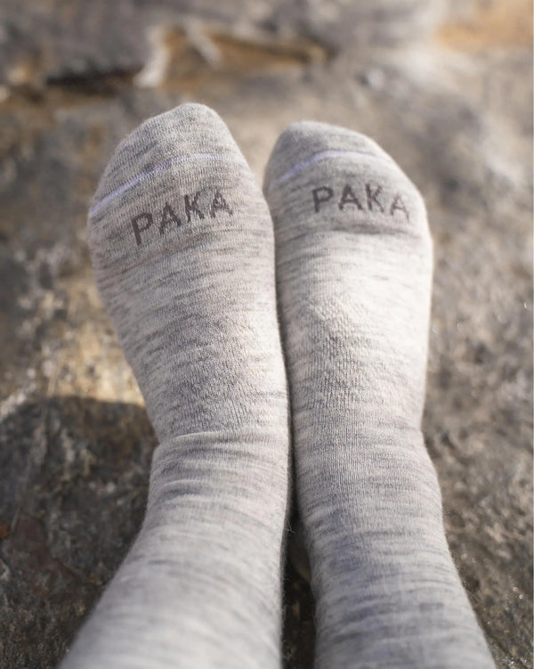Light Grey Essential Melange Alpaca Crew Socks on Feet on a Rock – PAKA Apparel