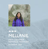 Mellanie, a PAKA team member, smiling in a purple jacket outdoors with mountains in the background
