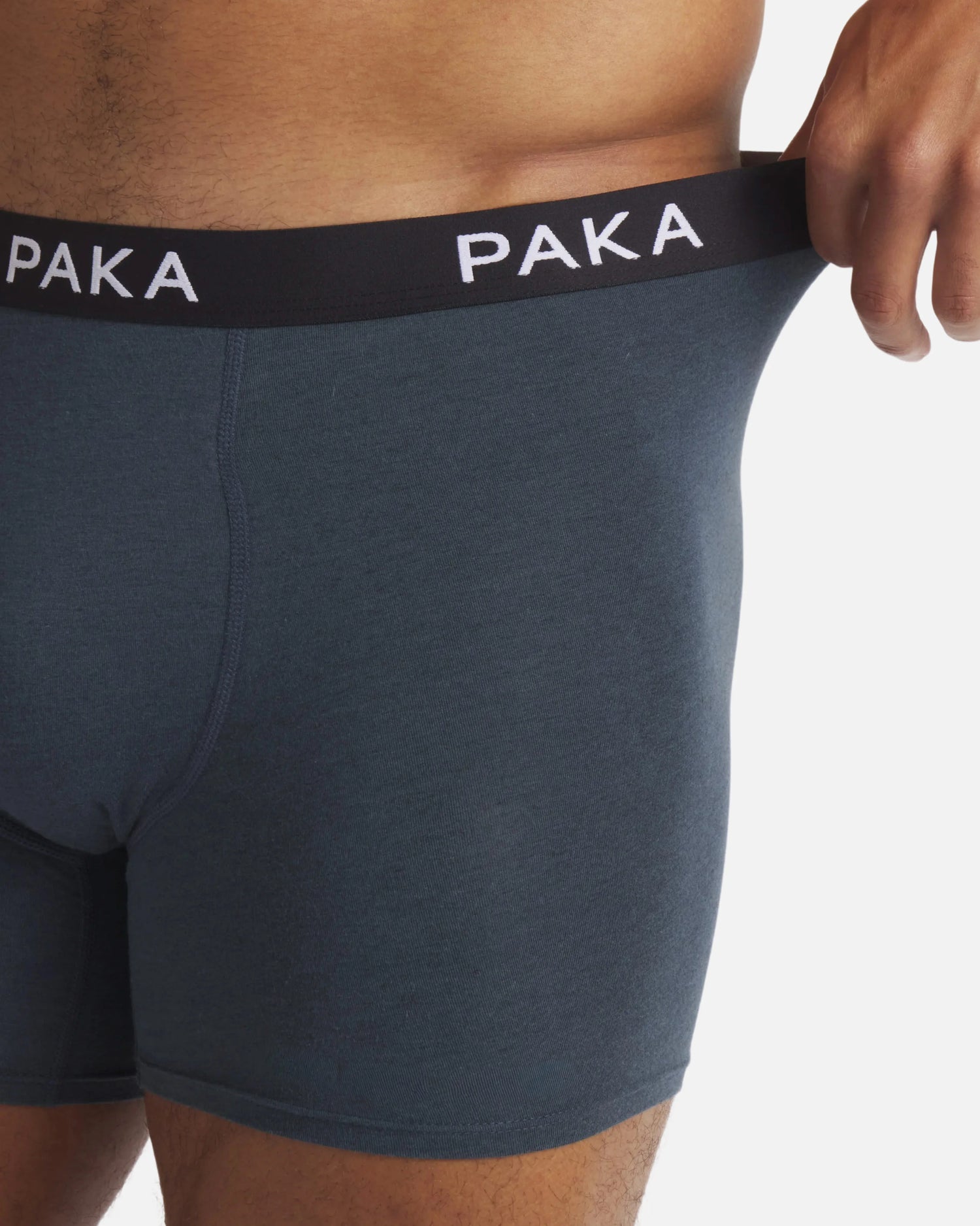 Front close up of Men’s Essential Boxer Brief in navy with PAKA waistband and stretchy fit on model
