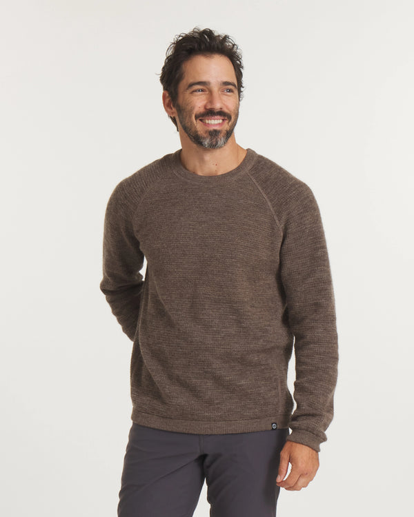 Man wearing a brown sweater on a white background
