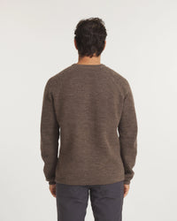 Man wearing a brown sweater on a white background
