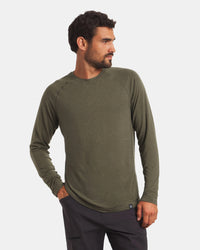 Front view of Men’s Sol Crew alpaca long-sleeve UPF sun shirt in Andean Moss on model, raglan sleeves, light gray background