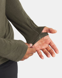 Close up of Men’s Sol Crew alpaca long sleeve UPF shirt sleeve showing thumbhole and flatlock seams on light gray background