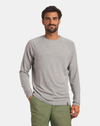 Front view of men’s Sol Crew long-sleeve alpaca sun shirt in heather grey, crewneck on model against light gray background