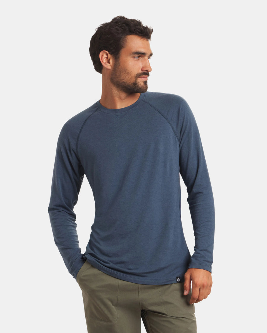 Man wearing a blue long-sleeve shirt on a white background