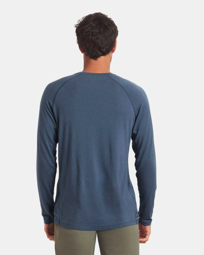 Man wearing a blue long-sleeve shirt on a white background