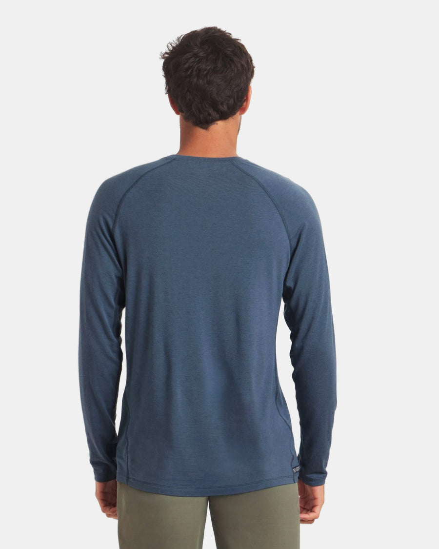 Man wearing a blue long-sleeve shirt on a white background