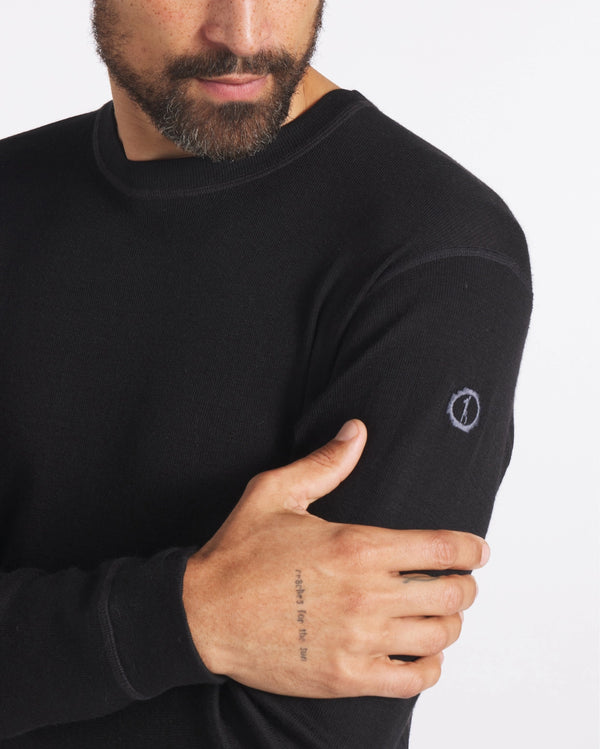 Close Up of Man with Hand on Arm in Black Alpaca Wool Thermal Underwear Top – PAKA Apparel