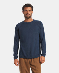 Front view of Men’s Ultralight Crew in navy on model, regular fit with raglan sleeves on light gray background