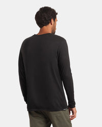 Back view of Men’s Aire Long Sleeve alpaca shirt showing long sleeves and relaxed fit on model against light gray background